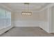 Formal dining room with tray ceilings, wainscoting and a modern chandelier at 818 Prada Ct, Lawrenceville, GA 30043