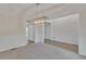 Elegant dining room with chandelier, wainscoting, and neutral color palette at 818 Prada Ct, Lawrenceville, GA 30043