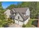 Aerial view of a two-story home with a two-car garage and a well-manicured lawn at 818 Prada Ct, Lawrenceville, GA 30043