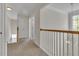 Upstairs hallway with carpeting, white bannister, and plenty of natural light at 818 Prada Ct, Lawrenceville, GA 30043