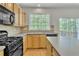 Bright eat-in kitchen boasts stainless appliances, wood cabinetry, and sliding door access to the deck at 818 Prada Ct, Lawrenceville, GA 30043