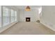 Cozy living room with fireplace, large windows, and plenty of natural light at 818 Prada Ct, Lawrenceville, GA 30043