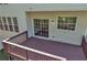 View of back of home featuring a wooden deck, access to the house, and two windows at 818 Prada Ct, Lawrenceville, GA 30043