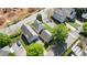 An aerial view showcases the rooftops of townhouses amidst green foliage, alongside roadways and new construction at 121 Dunleith Sw Pkwy, Marietta, GA 30008