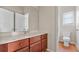 Bathroom vanity with cherry wood cabinets and marble top offers ample storage space at 121 Dunleith Sw Pkwy, Marietta, GA 30008