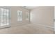 Bright bedroom features neutral walls, plush carpeting, and natural light from two windows and a glass-paneled door at 121 Dunleith Sw Pkwy, Marietta, GA 30008