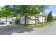 Two-story townhouse exterior with a two-car garage, landscaping, and street view at 121 Dunleith Sw Pkwy, Marietta, GA 30008