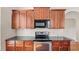 Kitchen with dark cabinetry, granite countertops, and stainless steel oven and microwave at 121 Dunleith Sw Pkwy, Marietta, GA 30008