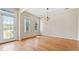 Sunlit living room featuring gleaming hardwood floors, large windows, and modern lighting fixtures at 121 Dunleith Sw Pkwy, Marietta, GA 30008