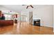 Open-concept living room with hardwood floors, fireplace, and kitchen view at 121 Dunleith Sw Pkwy, Marietta, GA 30008
