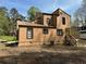 The back exterior of a tan home with a small deck and a lush, green backdrop at 2915 Creek Park Dr, Marietta, GA 30062