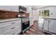 Updated kitchen boasts stainless steel appliances, mosaic backsplash, and access to outdoor deck at 2915 Creek Park Dr, Marietta, GA 30062