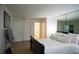 Spacious bedroom with sleek hardwood floors, closet, and a mirrored wall at 63 Fair Haven Se Way, Smyrna, GA 30080