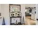 Entryway with table and mirror, leading to the open-concept living and kitchen area at 63 Fair Haven Se Way, Smyrna, GA 30080