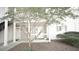 Close up exterior showing a white townhome with a porch and a trimmed tree at 63 Fair Haven Se Way, Smyrna, GA 30080