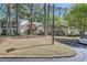 View of charming townhomes with mature trees, landscaping and a paved walkway at 63 Fair Haven Se Way, Smyrna, GA 30080