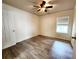 Bright bedroom with hardwood floors, a ceiling fan, and a window that provides natural light at 645 Crossbridge Aly, Johns Creek, GA 30022