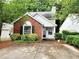 Charming brick-and-vinyl home with lush landscaping and a cozy front porch at 645 Crossbridge Aly, Johns Creek, GA 30022