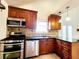 Updated kitchen featuring stainless steel appliances, granite countertops, and ample cabinet space at 645 Crossbridge Aly, Johns Creek, GA 30022
