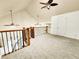 Bright living room boasts vaulted ceilings and fans plus decorative railing at 645 Crossbridge Aly, Johns Creek, GA 30022