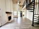 Bright living room features a fireplace and spiral staircase at 645 Crossbridge Aly, Johns Creek, GA 30022