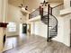 Open-concept living room with a fireplace and a unique spiral staircase to the second floor at 645 Crossbridge Aly, Johns Creek, GA 30022