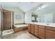 Bright bathroom features a glass shower, soaking tub, double vanity, and natural light at 3765 Clear Lake Nw Way, Acworth, GA 30101