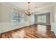 Spacious dining room with hardwood floors, chandelier, and ample natural light from large windows at 3765 Clear Lake Nw Way, Acworth, GA 30101