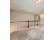Upstairs hallway with carpet and wooden railing at 3765 Clear Lake Nw Way, Acworth, GA 30101