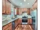 Well-lit kitchen showcasing wooden cabinets, granite countertops, stainless steel appliances, and elegant hardwood floors at 3765 Clear Lake Nw Way, Acworth, GA 30101