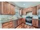 Well-lit kitchen showcasing wooden cabinets, granite countertops, stainless steel appliances, and elegant hardwood floors at 3765 Clear Lake Nw Way, Acworth, GA 30101