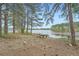 Scenic lake view with mature trees and a lakeside picnic table for outdoor enjoyment at 3765 Clear Lake Nw Way, Acworth, GA 30101