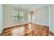 Bright living room featuring hardwood floors, neutral walls, a large window, and a glass panel door leading to the outside at 3765 Clear Lake Nw Way, Acworth, GA 30101