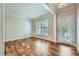 Bright living room featuring hardwood floors, neutral walls, a large window, and a glass panel door leading to the outside at 3765 Clear Lake Nw Way, Acworth, GA 30101