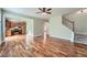 Open-concept layout with hardwood floors connecting the living area, kitchen, and staircase to the upper level at 3765 Clear Lake Nw Way, Acworth, GA 30101
