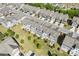 Aerial view of townhomes located at 8335 Village Pl with grassy lawns, landscaping, and parking at 8335 Village Pl, Suwanee, GA 30024