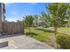 Backyard featuring a concrete patio, a lawn, several young trees, a wooden fence and view of the neighborhood at 8335 Village Pl, Suwanee, GA 30024