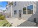 Backyard featuring a concrete patio, a sliding door, and a lawn that extends to the edge of the townhome at 8335 Village Pl, Suwanee, GA 30024