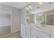 Bright bathroom boasts a double sink vanity with white countertop and stylish finishes at 8335 Village Pl, Suwanee, GA 30024