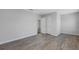 Bedroom with grey toned laminate floors and a double door closet with neutral paint at 8335 Village Pl, Suwanee, GA 30024