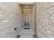 Covered entryway featuring a modern gray front door and brick walls at 8335 Village Pl, Suwanee, GA 30024