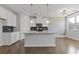 Modern kitchen featuring white cabinets, granite countertops, and stainless steel appliances at 8335 Village Pl, Suwanee, GA 30024