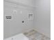 The laundry room has tile flooring, a utility sink, and washer and dryer hookups at 8335 Village Pl, Suwanee, GA 30024