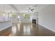 Bright living room with fireplace and hardwood floors open to the kitchen at 8335 Village Pl, Suwanee, GA 30024