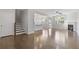 Open-concept living room with hardwood floors, fireplace, and natural light at 8335 Village Pl, Suwanee, GA 30024