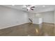 Open living room with hardwood floors, ceiling fan, and staircase to upper level at 8335 Village Pl, Suwanee, GA 30024