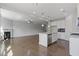 Open-concept living room and kitchen with hardwood floors and fireplace at 8335 Village Pl, Suwanee, GA 30024