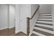 Hardwood staircase with stained wood railing and white risers at 8335 Village Pl, Suwanee, GA 30024