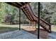 Backyard area showing patio, stairs, and lush natural greenery at 2822 Savannah Walk Cv, Suwanee, GA 30024