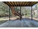 Backyard patio features exposed beams and stairs leading to an elevated area at 2822 Savannah Walk Cv, Suwanee, GA 30024